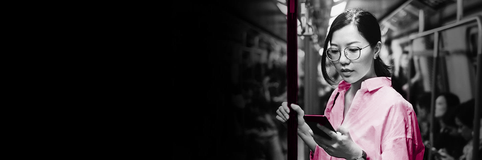 Woman on public transit looking at her phone