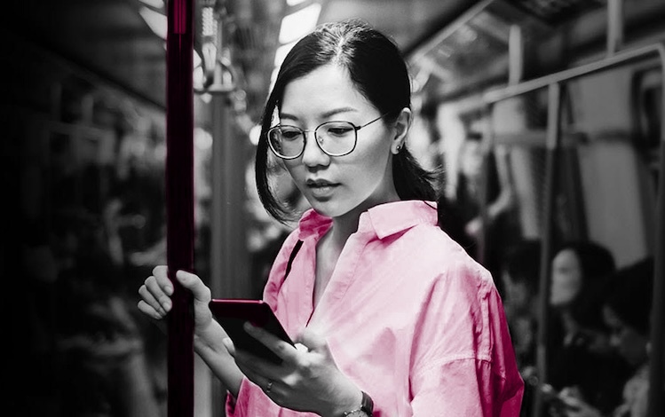 Woman on public transit looking at her phone